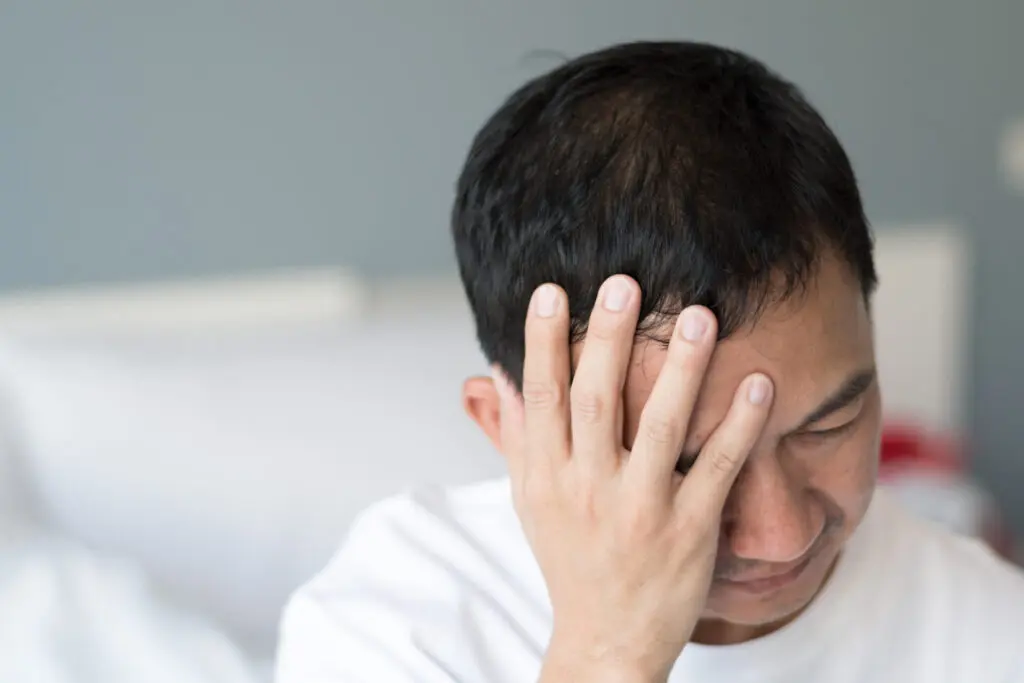 man with headache from Post Concussion Syndrome