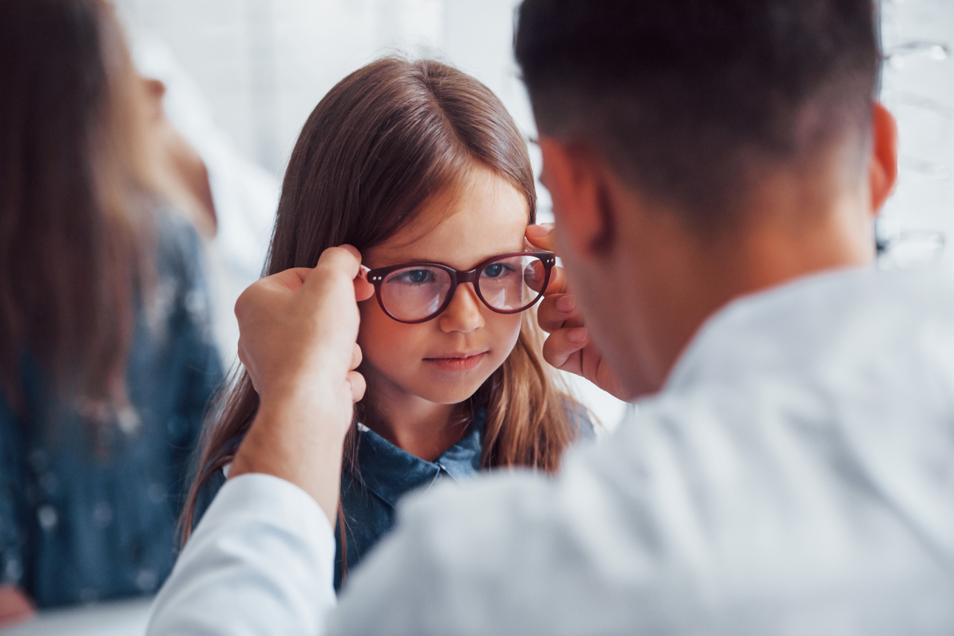 Child getting fitted for iseikonic glasses